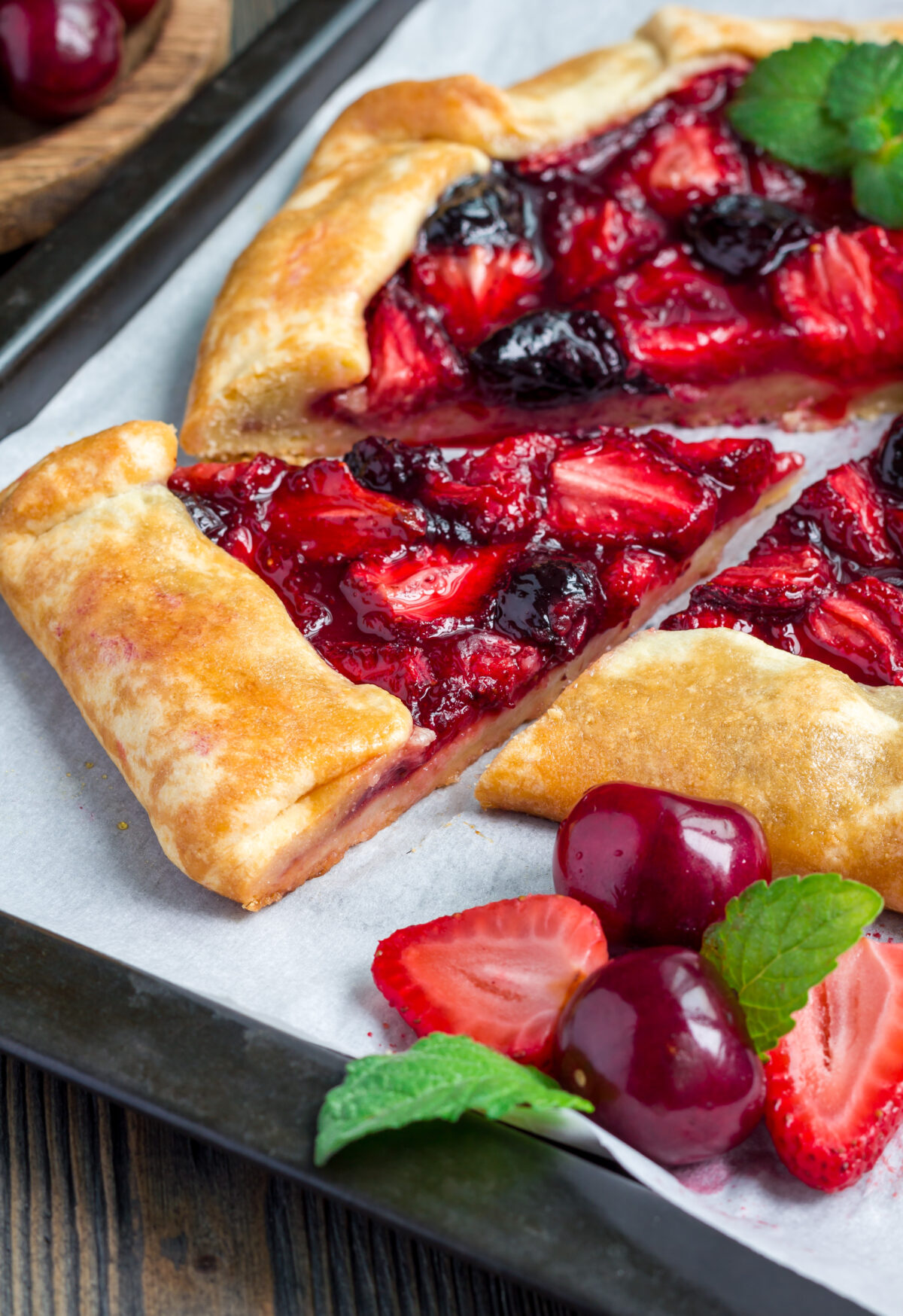 strawberry cherry galette on a baking sheet