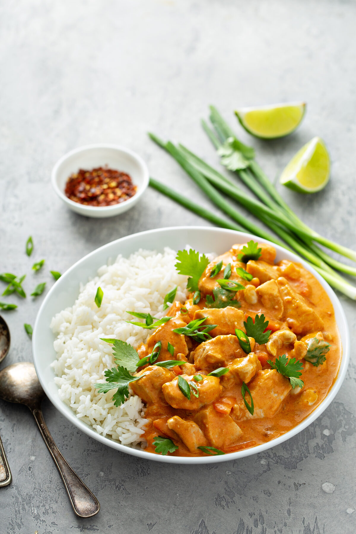 chicken and cashew curry on rice in a serving bowl
