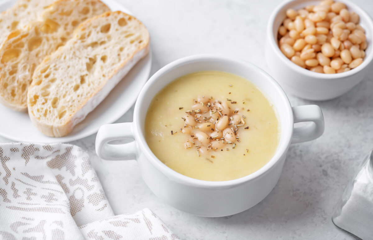 creamy white bean soup topped with rosemary and served with crust bread