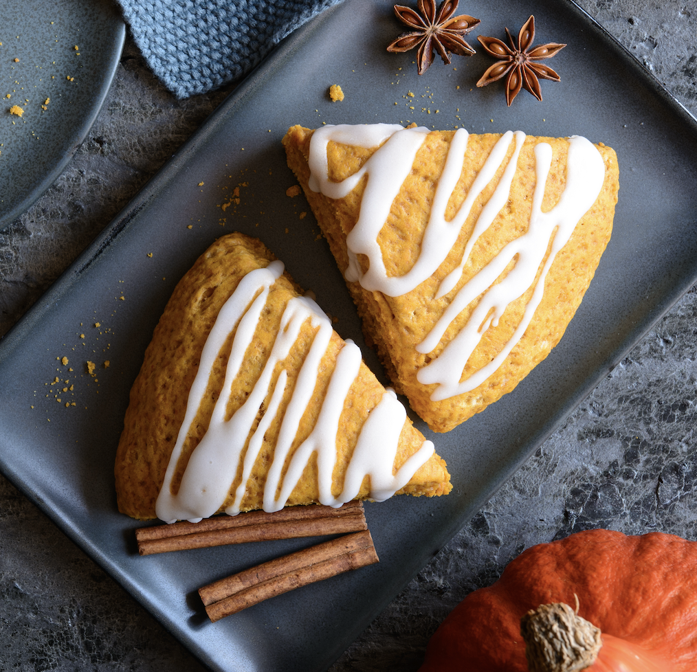 pumpkin scones cut into wedges with a maple drizzle