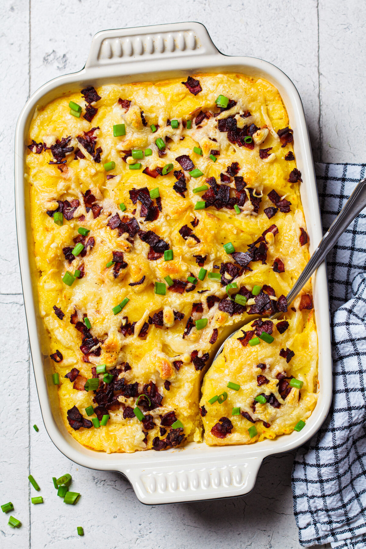 twice baked potato casserole with bacon bits and green onions