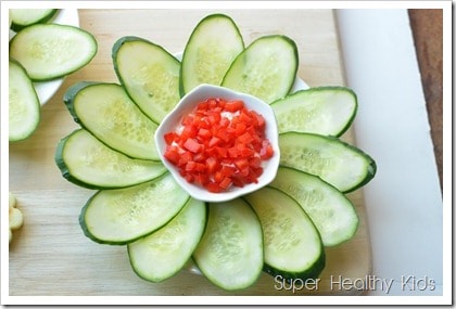 Cucumber flowers with pepper yogurt cheese spread. Strained yogurt makes a high protein dip, perfect for veggies like cucumbers!