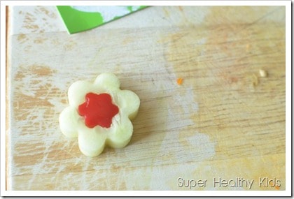 Cucumber flowers with pepper yogurt cheese spread. Strained yogurt makes a high protein dip, perfect for veggies like cucumbers!